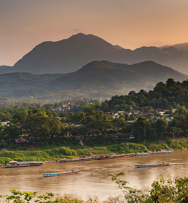 Mountains and boats on the river in Luang Prabang, Laos